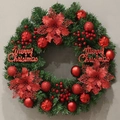 Detailed close-up of a Christmas wreath with red flowers, berries, and Merry Christmas sign - 60CM Red Christmas Flower Style
