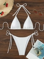 White ribbed bikini set with halter top and side-tie bottoms on a wooden backdrop - White