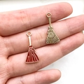 Close-up of red enamel and gold broomstick charms for DIY Halloween jewelry making - Reddish Brown Broom