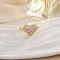 Detailed view of a gold-plated ring with a heart-shaped pink gem and pavé diamonds - Pink Heart Gemstone Inlaid Style (JZ0140)
