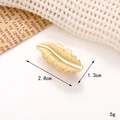 Detail of golden feather shoe charm showing dimensions 2.8cm by 1.3cm on a soft background - C250 Gold Leaf