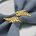 Golden metal wheat spike napkin ring holding a blue fabric napkin on a ceramic plate - Simulation Gold Wheat Ear Napkin Ring / 1 Piece / OPP Bag