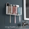 Wall-mounted three-cup toothbrush holder with storage slot and ecoco logo in bathroom - 3-Cup Set