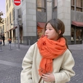 Orange thick wool scarf with fringe styled on a model in a beige coat for winter - Thickened Tassel Style (350g) / 200*70cm / Orange Red