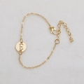 Gold hollow round charm bracelet featuring an engraved letter E with adjustable chain - Gold E
