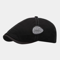 Detail view of the black ivy cap featuring a side embroidery patch and brown edge piping - Black