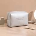 Sleek silver waterproof cosmetic bag with Travel & Fashion text and matching hand strap - Octagonal Pouch / Silver