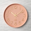 Minimalistische 30 cm Wanduhr in Korallenrosa mit goldenen 3D-Zahlen auf Marmorhintergrund - Hellrosa Zifferblatt Goldene Ziffern Rosa Rahmen