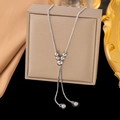 Elegant silver-tone Y-shaped snake chain necklace with polished beads on a display case - H1158 Adjustable Slider Bead / Steel