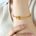 Polished gold knot bangle bracelet for women in a minimalist fashion style - Thick Knot Style (Z128) / Gold