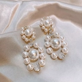 Elegant vintage pearl and zircon stud earrings on silk fabric background - Silver