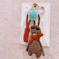 Detailed close-up of brown knitted bear charm with orange scarf on wooden hook - Bear with Scarf