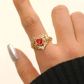 Adjustable golden ring featuring a red heart zircon and delicate floral leaf engraving - KC Gold (Heart Style)