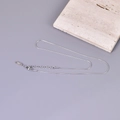 Detailed macro view of the silver snake chain necklace featuring K18 stamp on the tag - 40+5cm / Silver - English Tag