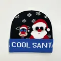 Close-up of knit beanie featuring Cool Santa pattern and snowflakes on black background - Style 8 (Black Blue Patchwork COOL SANTA)