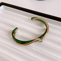 Detail of wave-shaped gold-plated bangle featuring layered translucent green inlay - Green Wave Metal Splicing Style (1#手镯-绿色-真金电镀)