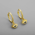 Detailed view of gold evil eye hoop earrings with a central blue gemstone and pavé setting - Blue Zircon Eye Earrings - Gold