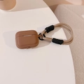 Detail view of brown silicone case for AirPods with beige and black braided hand strap - Striped Brown + Black Coffee Lanyard