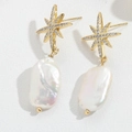 Elegant gold star earrings with white baroque pearl pendants for a minimalist look - Baroque Pearl Starburst Style