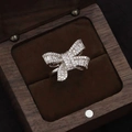 Silver bow ring with sparkling zircons displayed in a luxury wooden jewelry box - J068 Silver Zircon Bow / Size 7