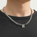 Close-up of silver Gothic letter H pendant on a Cuban link chain necklace worn by a model - Silver Letter U