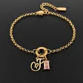 14K gold plated stainless steel bracelet with cursive letter F and pink crystal heart charms - Letter F