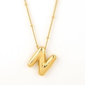 Chubby bubble initial necklace featuring a gold-plated letter N on a delicate bead chain - Gold - N