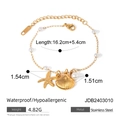 Gold stainless steel starfish and shell bracelet with white pearls on white background - Gold Starfish Shell Bracelet (JDB2403010)