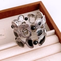 Close-up of vintage hollow silver alloy bangle with black enamel on a velvet tray - Silver-Black