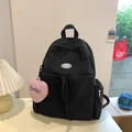 Minimalist black nylon backpack with a pink heart charm and Luck Getl logo detail - Black