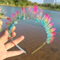 Rainbow crystal moon crown headband held against a scenic lakeside background - Blue Yellow Rose Tri-color