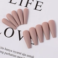 Close-up of matte nude pink long coffin press-on nails displayed on a magazine page - Dark Khaki