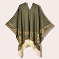 Detail of army green knitted poncho featuring ethnic patterns and beige tassel fringe - 130x150cm / Pullover Poncho Origin Green