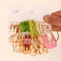 Golden earring set with pearls and white butterfly charms held in hand for display - Earrings Set (3 Cards-A)