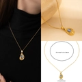 Collier en acier titane doré avec pendentif goutte bleue sur modèle et guide de taille - Pierre d'Œil de Chat Violette