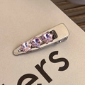 Detail of silver hairpin with three light purple star-shaped crystals in a prong setting - Purple Star Decor Duckbill Clip