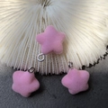 Detailed view of pink flocked star pendants with silver metal loops on white coral - Pink