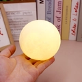 Spherical cartoon rabbit moon night light with warm yellow glow held in hand - Single Moon Lamp (8.5cm)
