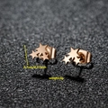 Three gold stainless steel star stud earrings set against a textured dark grey background - Star / Rose Gold