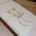 Macro detail of elegant gold S-curve tassel earrings with white pearls on velvet - Gold Pearl (44# Silver Earring Post)