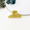 Detail of small translucent amber hair claw clip with jelly texture on white background - Jelly Mini Claw - Straight Straw Yellow