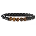 Macro detail of natural tiger eye beads and matte black stones on a beaded bracelet - Matte Black + Tiger Eye