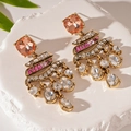Close-up of vintage gold earrings with orange square stones and crystal drop details - Gold Rhinestone Water Drop Dangle Earrings