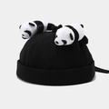 Detail of a black skullcap featuring two cute plush panda bears on top with adjustable strap - Black