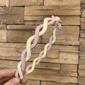 Detail of pink and beige matte twisted headband with non-slip inner teeth structure - Pink & White