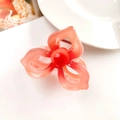Macro shot of gradient red flower hair claw with pearl heart and silver metal spring - 3-Petal Clover Orange Red