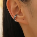 Close-up of retro silver skull ear cuff on model showing gothic punk style details - Antique Silver (10413)