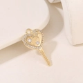 Detailed view of a gold heart-shaped key pendant featuring sparkling zircon star accents - Gold-Heart Key