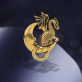 Vintage golden dragon and crescent moon brooch with detailed scales on a blue surface - Antique Gold Moon Dragon