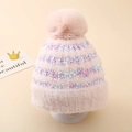 Detailed close-up of a pink knit hat featuring colorful stripes and a fluffy faux fur pompom - One Size (3-8 Years) / Pink